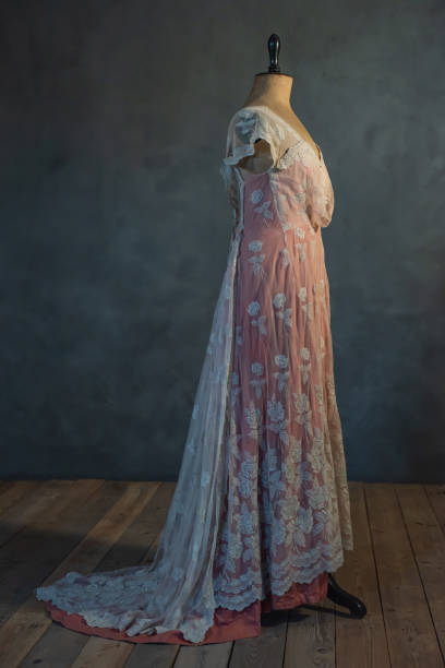 istock Vintage mannequin bust with pink victorian dress in empty room. Side view. 1210173931