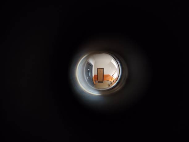 View to the hall through peephole eyelet in the door. View to the hall through peephole eyelet in the door. Slovakia peep hole stock pictures, royalty-free photos & images