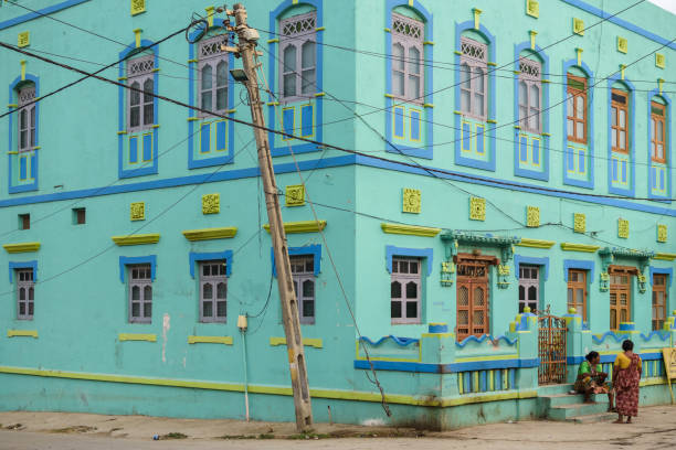 Diu #40 Diu, India - December 2018: An old,  bright turquoise green house with old-fashioned, colorful windows in the streets of the island town of Diu. diu island stock pictures, royalty-free photos & images