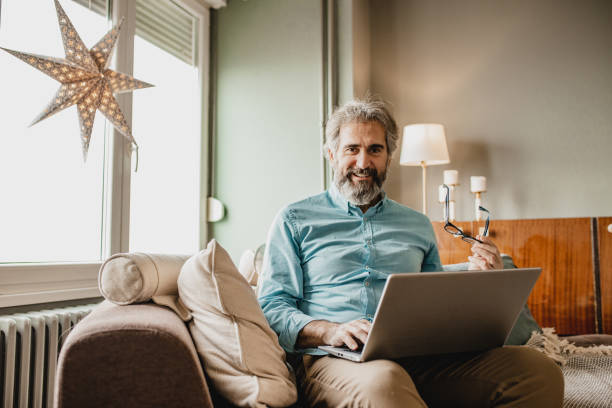istock Senior modern man with laptop at home 1210175191
