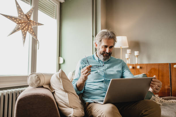 istock Senior modern man with laptop at home 1210175220
