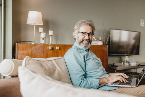 istock Senior modern man with laptop at home 1210175302