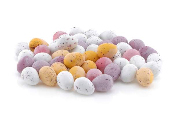 istock A selection of Yellow pink purple and white Easter candy eggs isolated on a white background 1210176749