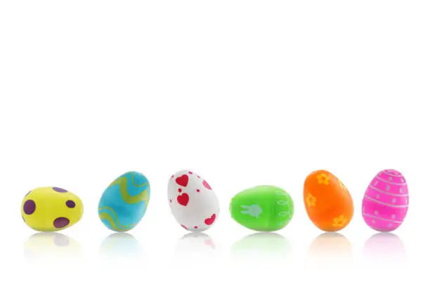 Photo of A set of Easter toy eggs on white with reflection