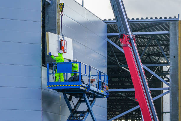 sandwich panels wall mounting using crane and scissor lift steel sandwich panels wall mounting using crane and scissor lift sandwich panel photos stock pictures, royalty-free photos & images