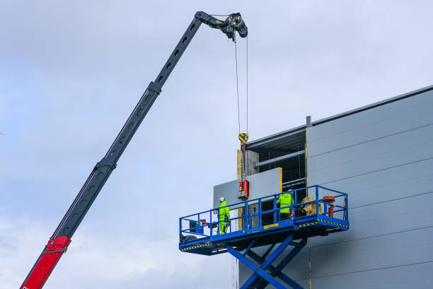 sandwich panels wall mounting using crane and scissor lift steel sandwich panels wall mounting using crane and scissor lift sandwich panel photos stock pictures, royalty-free photos & images