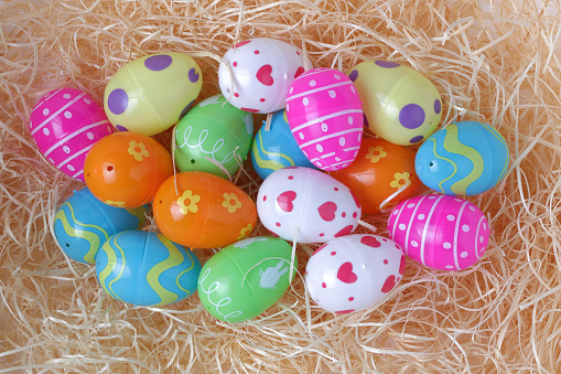 Toy Easter eggs on a bed of straw