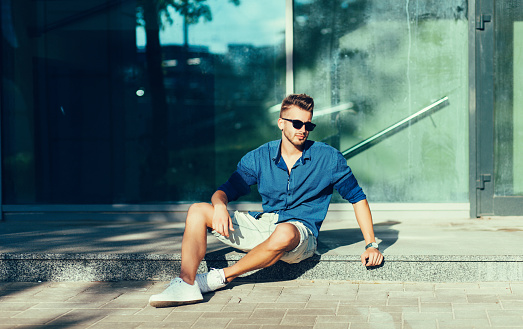 Fashionable man in a shirt and sunglasses. Summer clothes season