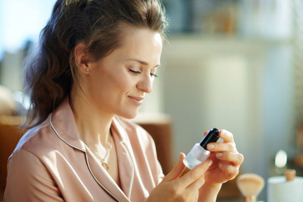 istock elegant housewife reading instruction on cosmetic elixir 1210178152