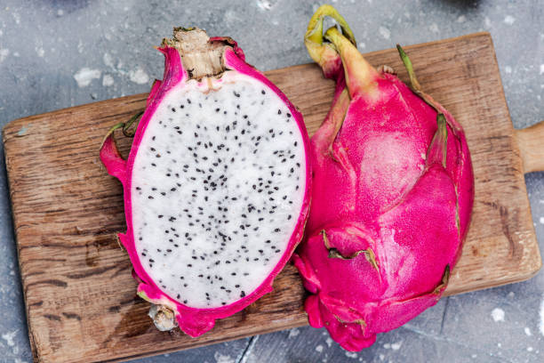 istock Pitahaya or Dragon Fruit Cut in Half on Board. Fresh Raw Exotic Fruits 1210178935