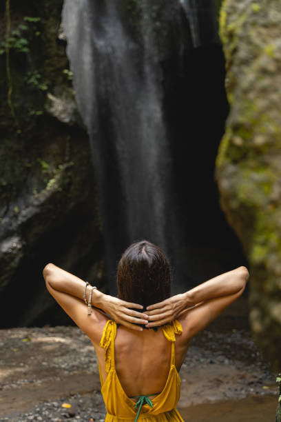 istock Relaxed young female person looking at waterfall 1210180308