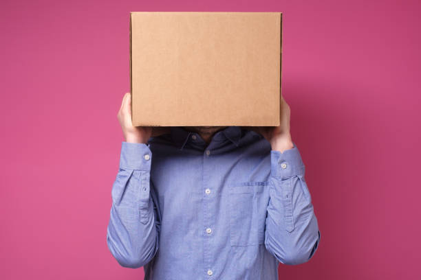 istock Anonymous business man with a cardboard box on his head concealing his identity 1210180458
