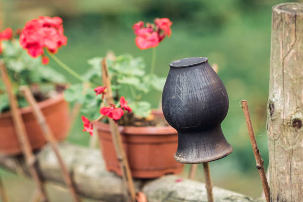 black clay pot on a wicker fence