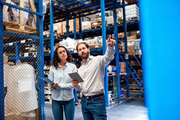 istock Business colleagues counting stocks in a warehouse 1210182349