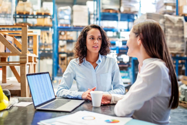 istock Businesswomen discussing over available warehouse stock 1210182368