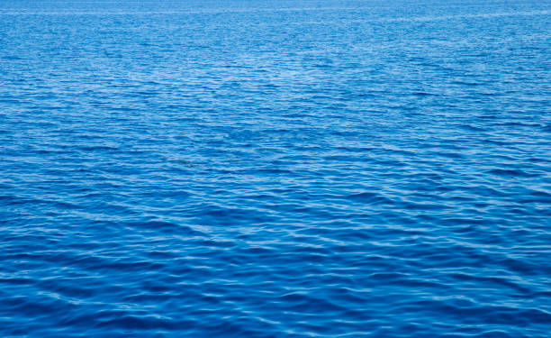 istock Blue water with sun reflections. Sea background 1210182445