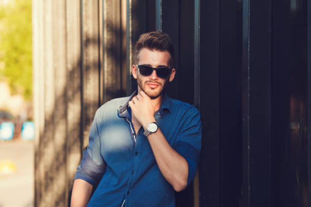istock Handsome caucasian model dressed in trendy shirt and sunglasses 1210183549