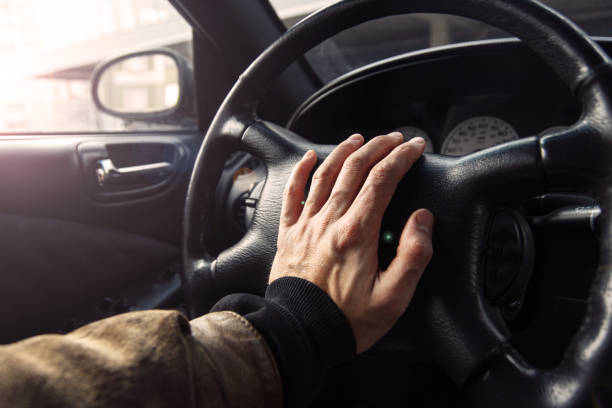istock driver clicks on the steering wheel signal while traveling. 1210183589