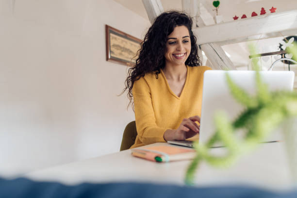 istock Beautiful woman working from her home office 1210183802