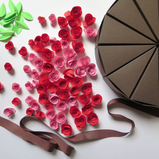istock pink red paper roses with brown cake shaped boxes 1210183808