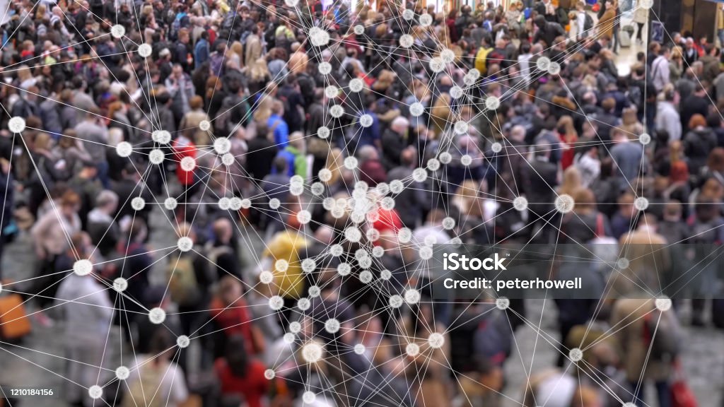 Coronavirus particles spreading in a crowd of people. Visualization of coronavirus multiplying with a background of people at a train station concourse. Coronavirus Stock Photo