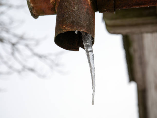 istock Melting icicles on the drainpipe. Thaw, temperature fluctuations 1210186374