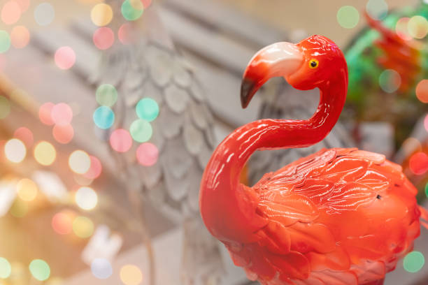 Colorful artificial ceramic flamingo toy, holiday home and garden decor concept, greeting, postcard with copyspace