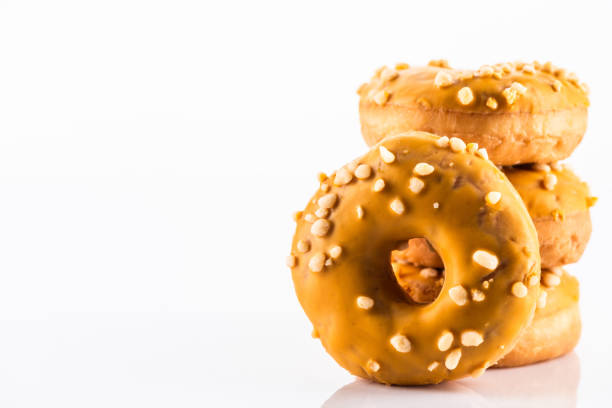 Salted Caramel Donut or Doughnuts on White Reflective Background with Copy Space.