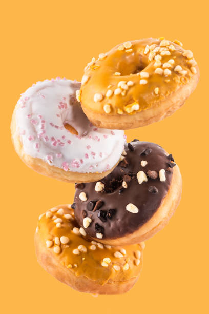 istock Flying Donut or Doughnut Creative Image. Falling Food On White Background. Food in Motion 1210187789