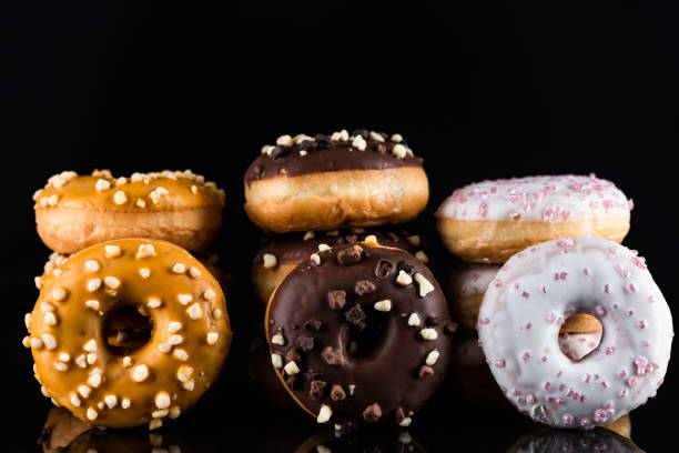 istock Donuts or Doughnuts Tower on Dark Background. Donut Stack Pile Food Background 1210188026