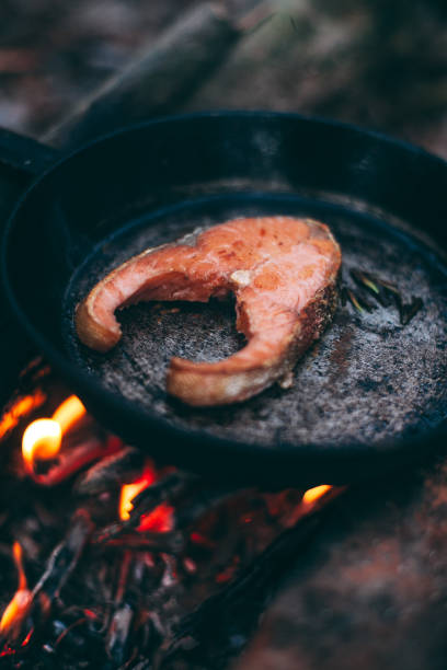 istock A piece of salmon in a pan over a open fire. 1210191742