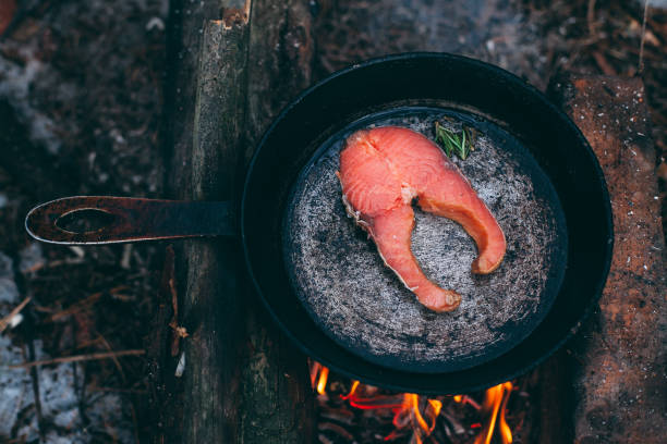 istock A piece of salmon in a pan over a open fire. 1210191856