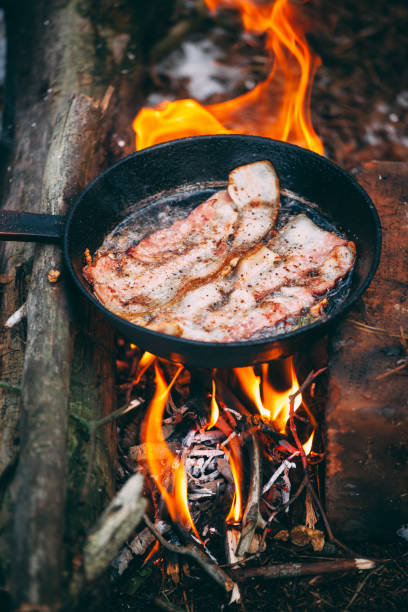 istock Slices of fried bacon in a pan. 1210191909