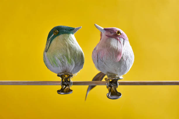 istock Fake birds with clips against a yellow background 1210192104