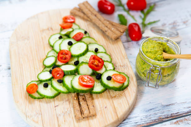 istock Vegetable salad with tomatoes, cucumber and olives. Christmas tree shape. 1210192484