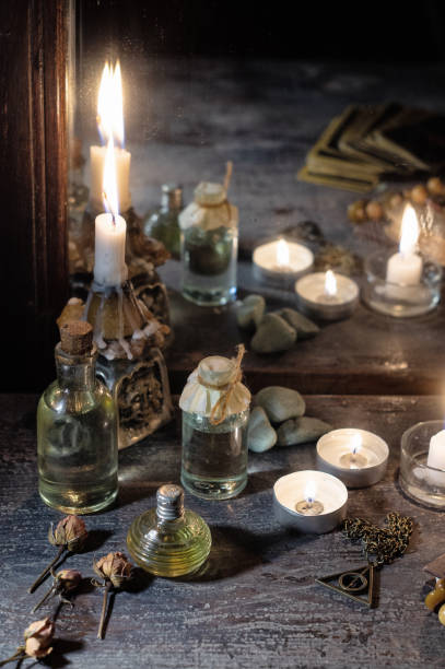 istock Burning candles, fortune-telling cards and tincture bottles are reflected in an old mirror 1210192490