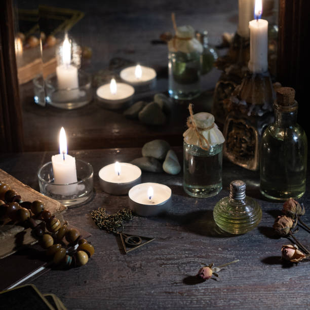 istock Burning candles, fortune-telling cards and tincture bottles are reflected in an old mirror 1210192506
