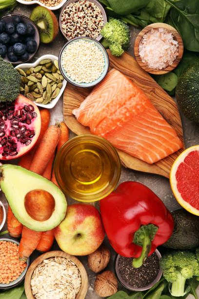 istock Healthy food clean eating selection: fish, fruit, vegetable, cereal, leaf vegetable on rustic background 1210193649