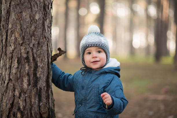 istock Toddler playing in a park, forest, looking with excitement 1210194098