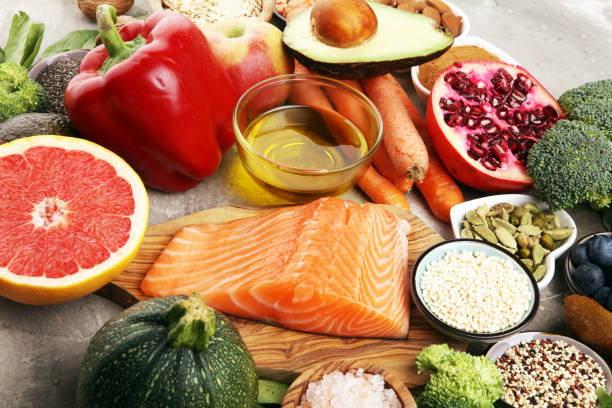 istock Healthy food clean eating selection: fish, fruit, vegetable, cereal, leaf vegetable on rustic background 1210195918