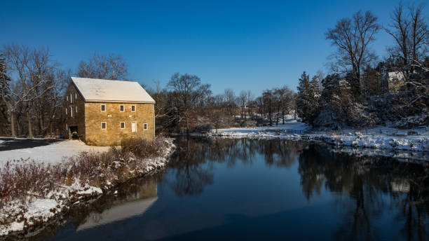 Stone mill in winter under an azure sky stock photo