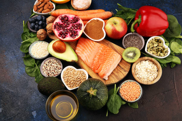 istock Healthy food clean eating selection: fish, fruit, vegetable, cereal, leaf vegetable on rustic background 1210196164