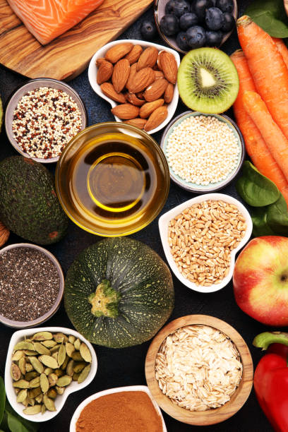 istock Healthy food clean eating selection: fish, fruit, vegetable, cereal, leaf vegetable on rustic background 1210196307