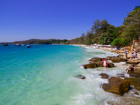 Koh Samet, Thailand - January 3, 2020: View of the relaxing in the sun on the popular Sai Kaew Beach.