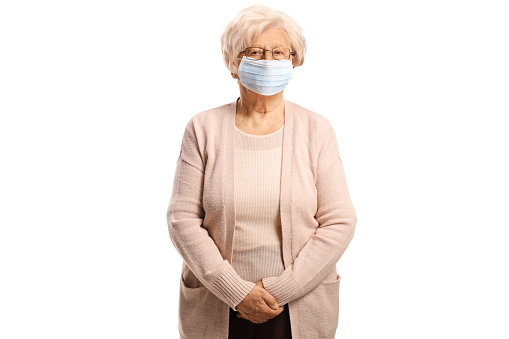 Senior woman wearing a protective face mask isolated on white background