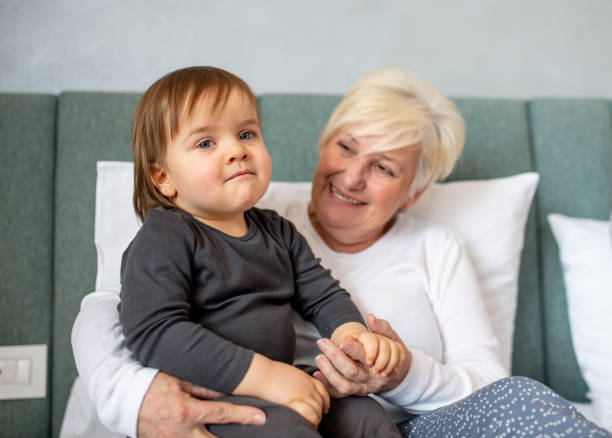 istock Grandma sitting and smiling with her grandson. 1210199258
