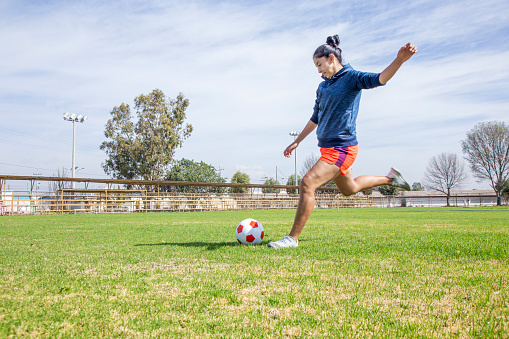 Latina woman playing soccer