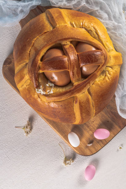 istock Portuguese traditional Easter cake. Folar with eggs on wooden table 1210205312