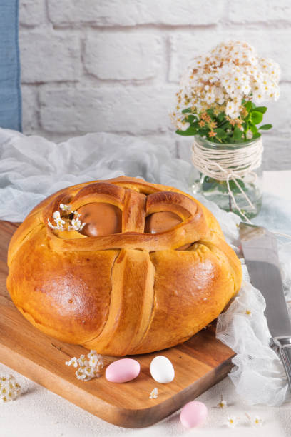 istock Portuguese traditional Easter cake. Folar with eggs on wooden table 1210205324