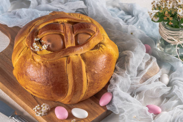 istock Portuguese traditional Easter cake. Folar with eggs on wooden table 1210205369